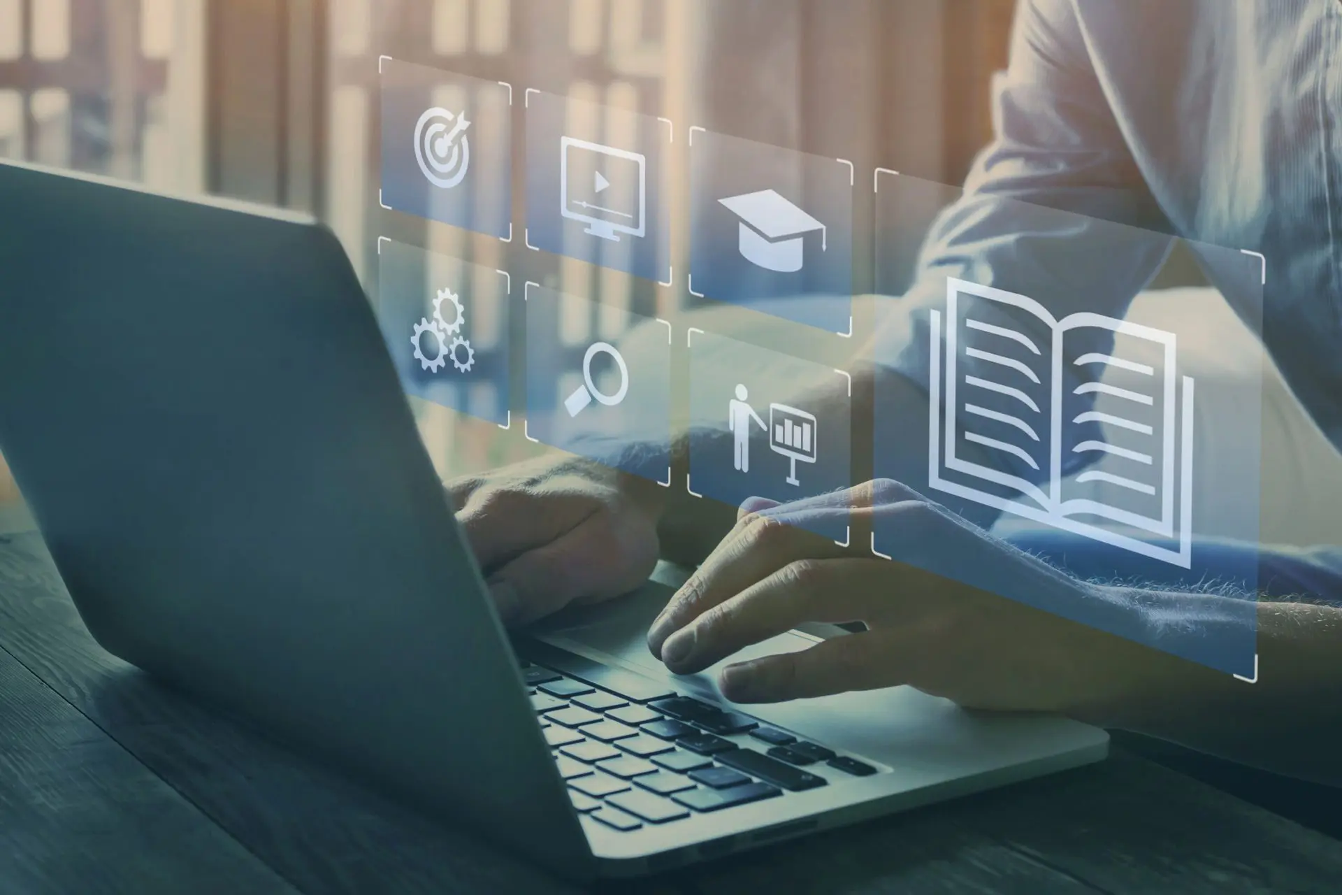 Person typing on laptop with digital graphics floating above the keyboard